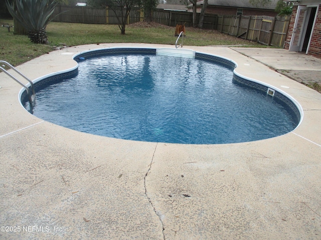 view of pool with a patio area, a fenced backyard, a fenced in pool, and a yard