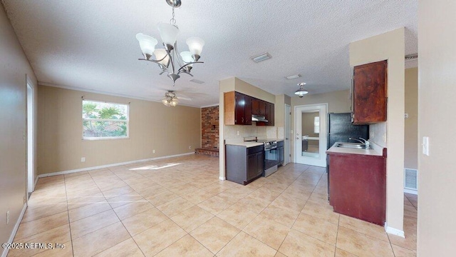 kitchen with light countertops, electric range, light tile patterned flooring, a sink, and under cabinet range hood