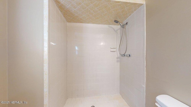 full bathroom with a shower stall and toilet