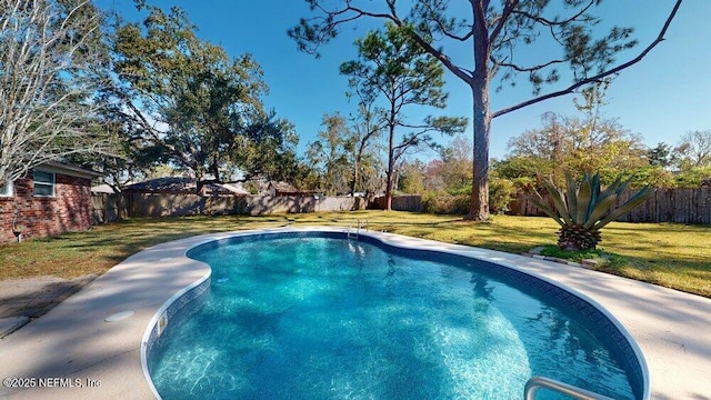 view of swimming pool featuring a fenced in pool, a fenced backyard, and a yard