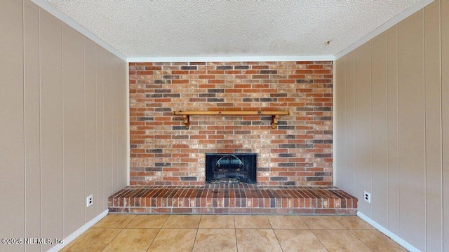 interior details featuring wooden walls, a brick fireplace, crown molding, and a textured ceiling