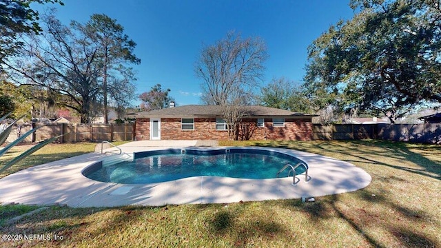 view of swimming pool with a fenced in pool, a patio area, a fenced backyard, and a yard