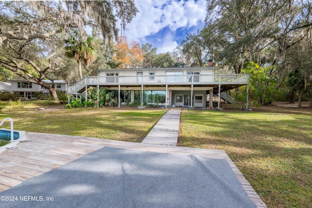 exterior space with a deck and a front yard