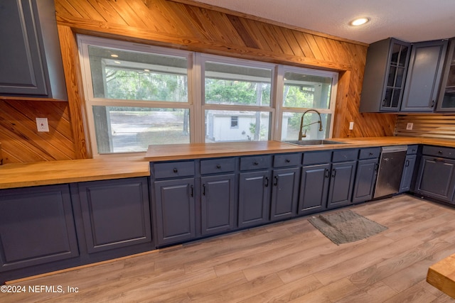 kitchen with plenty of natural light, dishwasher, sink, and wooden counters