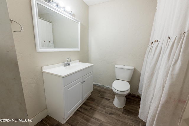 bathroom featuring hardwood / wood-style floors, vanity, and toilet