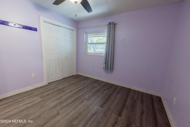 unfurnished bedroom featuring hardwood / wood-style floors, ceiling fan, a textured ceiling, and a closet