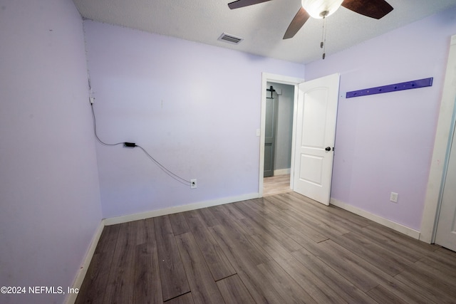 unfurnished room with hardwood / wood-style floors, a textured ceiling, and ceiling fan