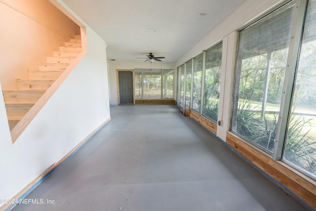 unfurnished sunroom with plenty of natural light and ceiling fan