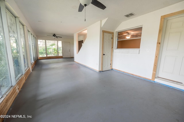 unfurnished sunroom with ceiling fan