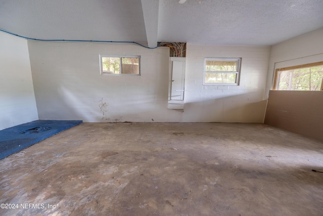 unfurnished room featuring concrete flooring and a textured ceiling