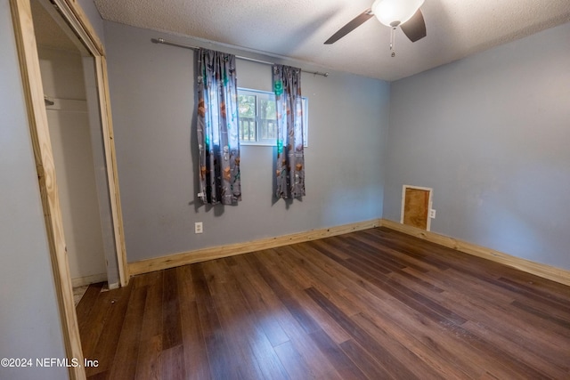 unfurnished bedroom featuring ceiling fan, wood-type flooring, a textured ceiling, and a closet