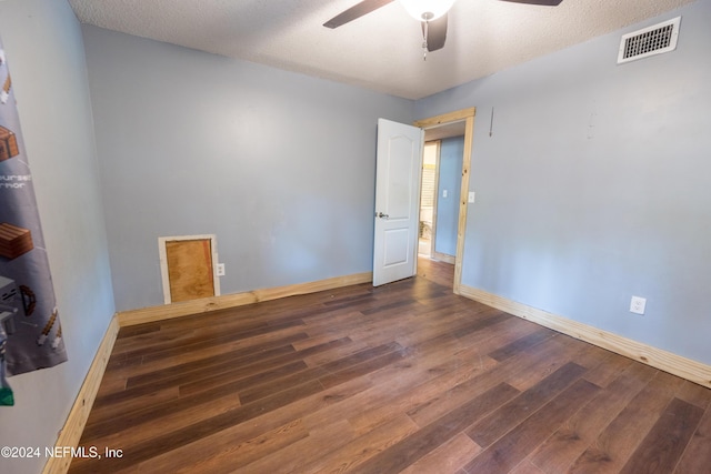 unfurnished room with a textured ceiling, ceiling fan, and dark hardwood / wood-style floors