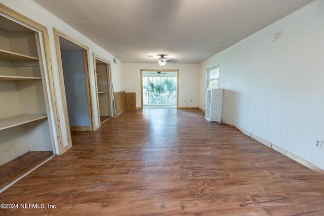 interior space featuring hardwood / wood-style floors, ceiling fan, and a textured ceiling