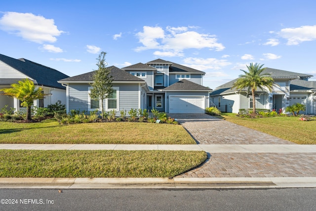 view of front of home featuring a garage and a front lawn