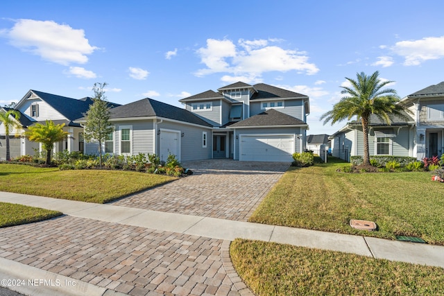 view of front property featuring a garage and a front lawn