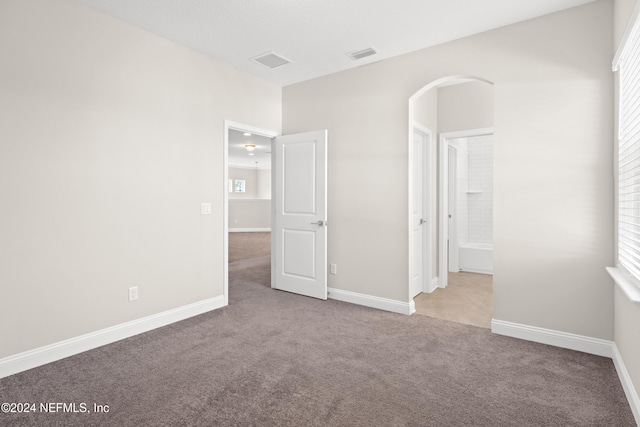 spare room featuring light colored carpet