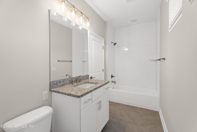 full bathroom featuring tile patterned floors, vanity, toilet, and tiled shower / bath