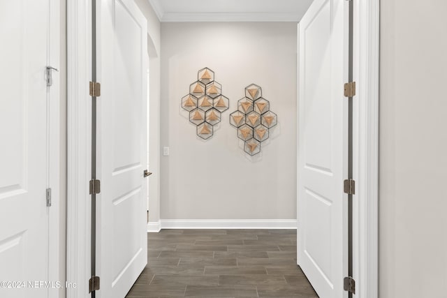 hallway featuring dark hardwood / wood-style floors and ornamental molding