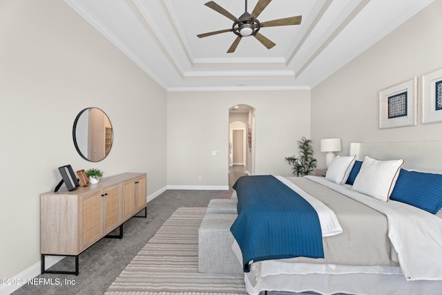 bedroom featuring carpet flooring, ceiling fan, ornamental molding, and a tray ceiling