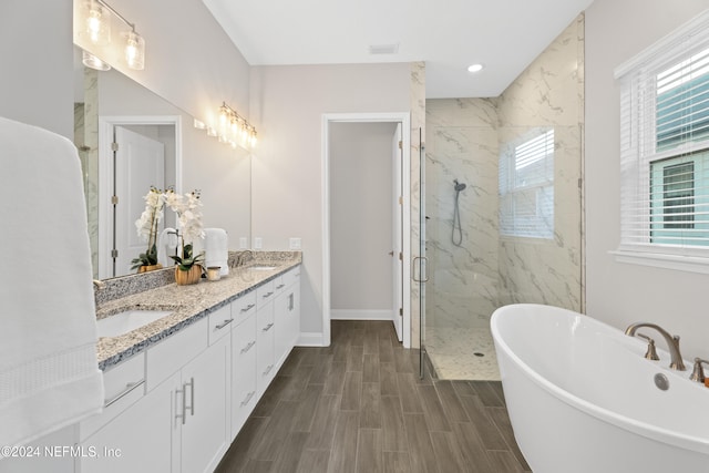 bathroom featuring plus walk in shower and vanity