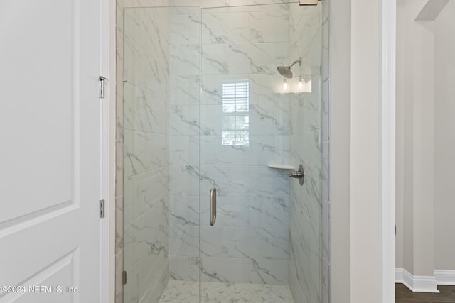 bathroom featuring an enclosed shower and hardwood / wood-style flooring