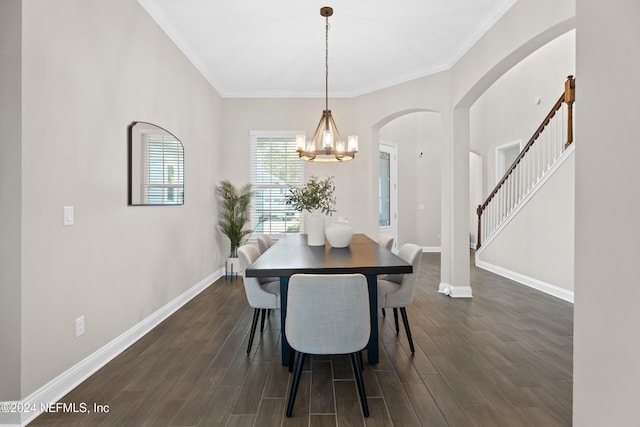 dining room featuring a notable chandelier, dark hardwood / wood-style flooring, and ornamental molding