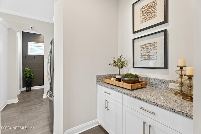 interior space featuring hardwood / wood-style floors, vanity, and ornamental molding