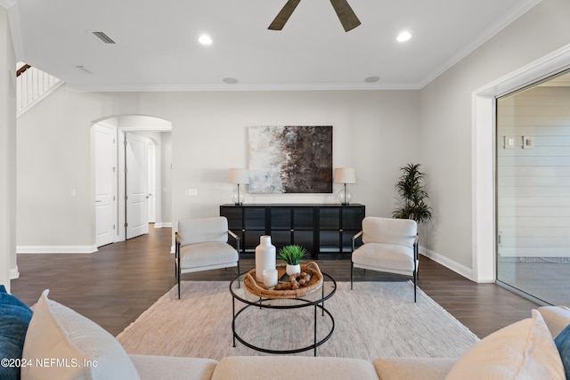 living room with ceiling fan, dark hardwood / wood-style floors, and ornamental molding