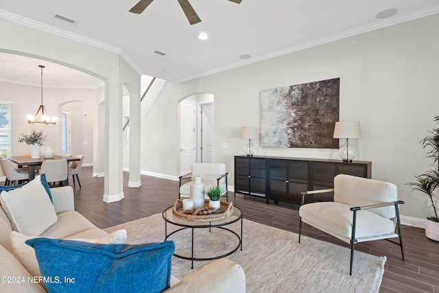 living room with hardwood / wood-style floors, ceiling fan with notable chandelier, and ornamental molding