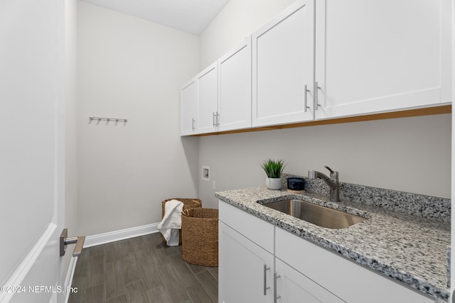 laundry area featuring cabinets, hookup for a washing machine, dark hardwood / wood-style flooring, a textured ceiling, and sink