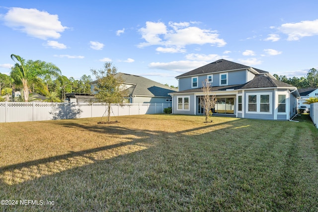 back of house with a yard