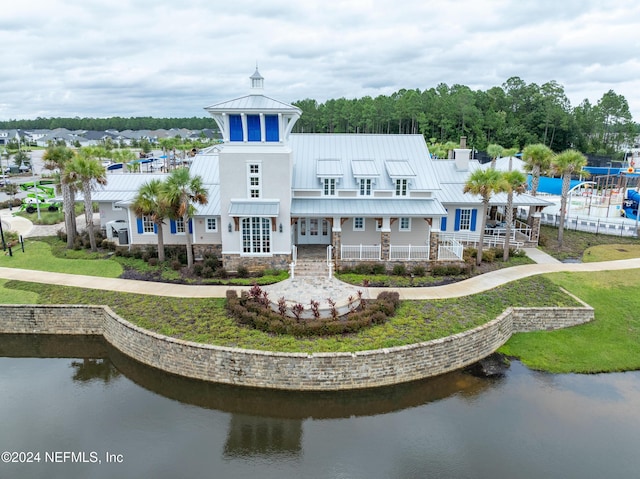 back of property with french doors and a water view