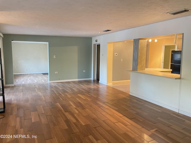 unfurnished living room featuring hardwood / wood-style floors