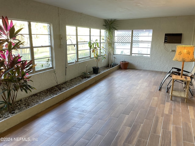 sunroom featuring an AC wall unit