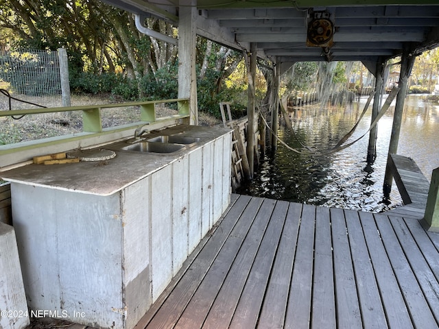 view of dock with sink and a water view