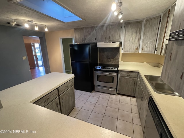 kitchen with sink, a textured ceiling, appliances with stainless steel finishes, and a skylight