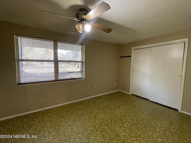 unfurnished bedroom featuring a closet and ceiling fan