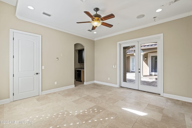 spare room with crown molding, french doors, and ceiling fan