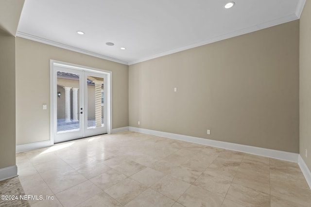 unfurnished room featuring french doors and crown molding