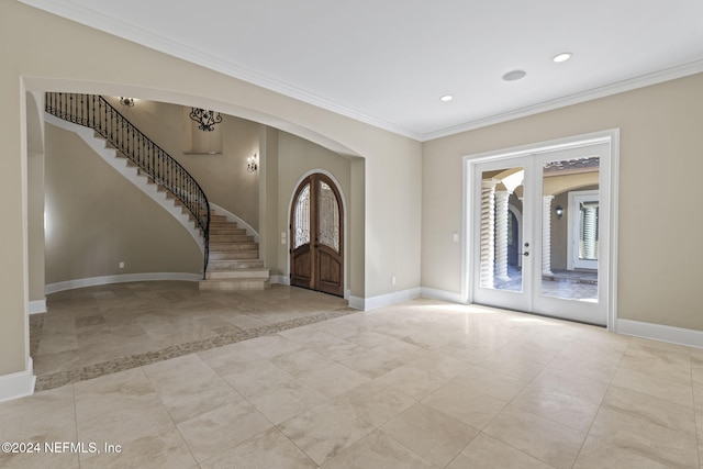 entryway with french doors, a wealth of natural light, and crown molding