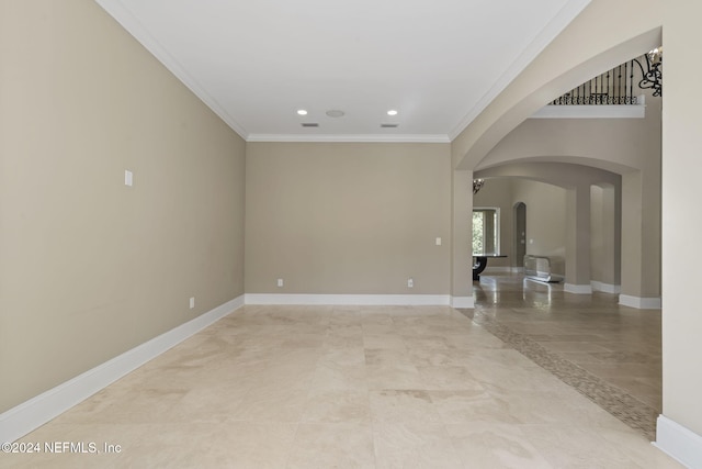 unfurnished room featuring a notable chandelier and ornamental molding