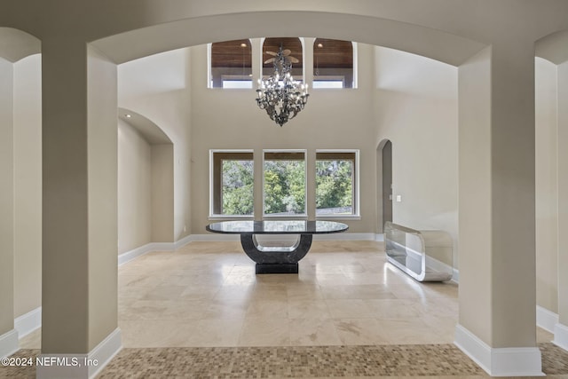 foyer with a towering ceiling and an inviting chandelier