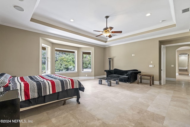 bedroom with a tray ceiling, ceiling fan, and crown molding