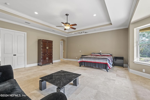 bedroom with a raised ceiling, ceiling fan, and crown molding