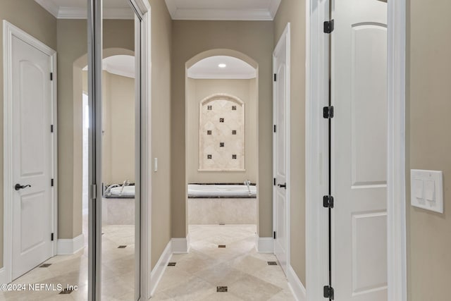 hallway featuring light tile patterned floors and ornamental molding