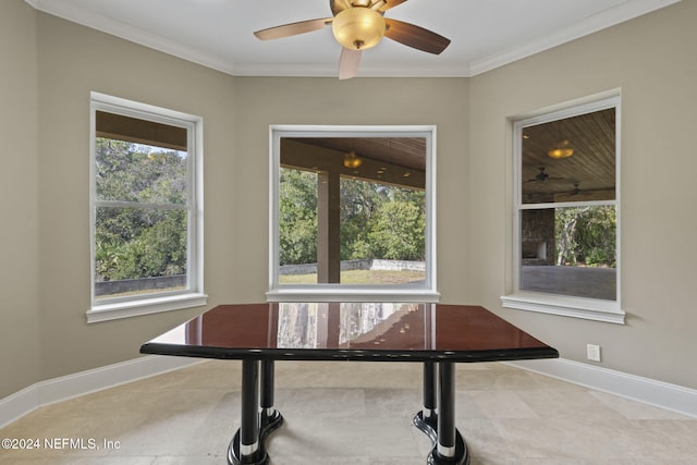 dining room featuring crown molding, a healthy amount of sunlight, and light tile patterned flooring