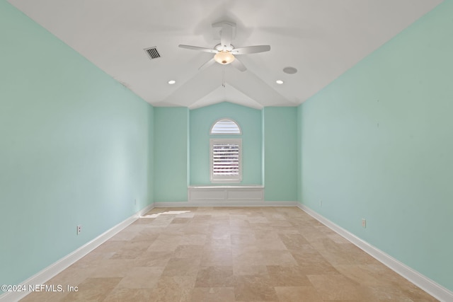 spare room featuring ceiling fan and vaulted ceiling