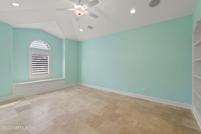 spare room with ceiling fan and lofted ceiling