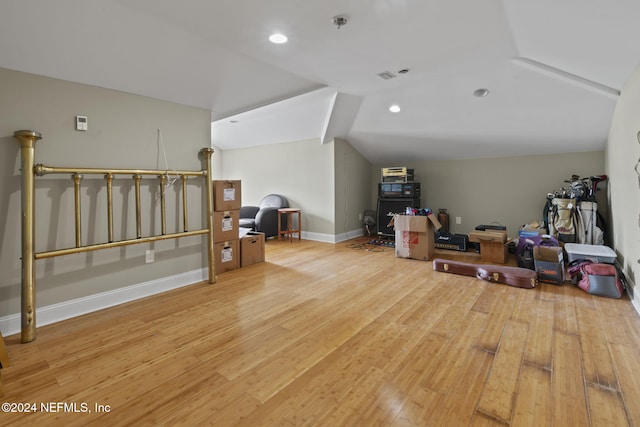 bonus room with lofted ceiling and light wood-type flooring