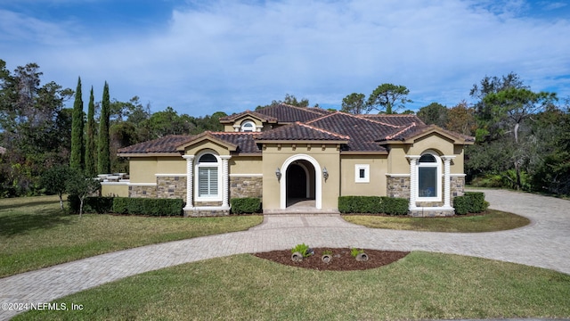 mediterranean / spanish-style home featuring a front lawn